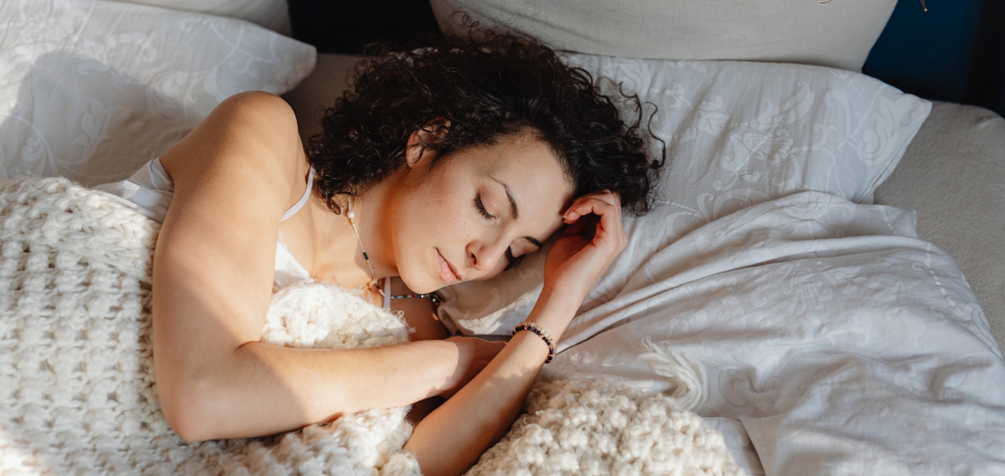 Gemini said A high-angle, close-up shot shows a woman with dark curly hair sleeping peacefully in a bed. 