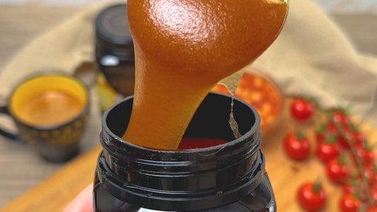 Thick Manuka Honey being taken from the jar with a teaspoon